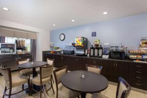 a restaurant with two tables and chairs and a counter at Microtel Inn & Suites by Wyndham Klamath Falls in Klamath Falls