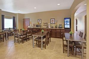 a restaurant with tables and chairs and a counter at Microtel Inn & Suites - Cartersville in Cartersville