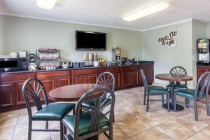 a restaurant with two tables and chairs and a bar at Microtel Inn by Wyndham Wilson in Wilson