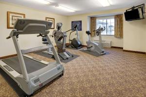 a fitness room with treadmills and exercise bikes at Microtel Inn & Suites by Wyndham Indianapolis Airport in Indianapolis