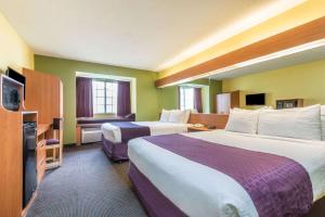 Habitación de hotel con 2 camas y TV de pantalla plana. en Microtel Inn & Suites by Wyndham Auburn, en Auburn