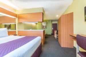 a hotel room with a bed and a kitchen at Microtel Inn & Suites by Wyndham Auburn in Auburn +7 photos