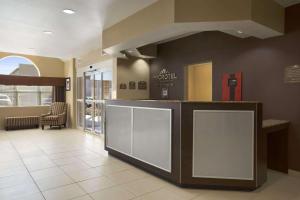 a lobby of a hotel with a reception counter at Microtel Inn & Suites by Wyndham Odessa TX in Odessa