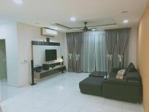 a living room with a couch and a television at Sky Loft Premium Bukit Indah with Garden View & Nflix HBO A30 in Johor Bahru