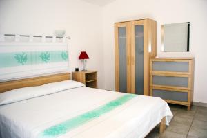 a bedroom with two beds and a mirror at Casa ARCU DE CHELU in Santa Lucia