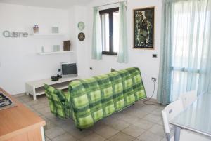 a living room with a couch and a tv at Casa ARCU DE CHELU in Santa Lucia