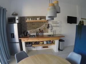 a kitchen with a table and a refrigerator at 41 on Serruria in Stellenbosch