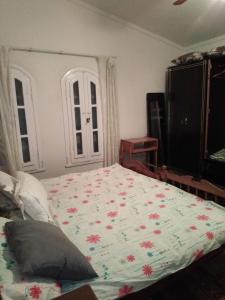 a bedroom with a large bed with flowers on it at Villa Dr. Atef Darwish in Alexandria