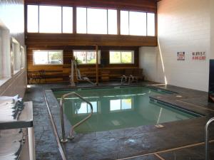 a swimming pool in a building with a large window at Motel West in Idaho Falls