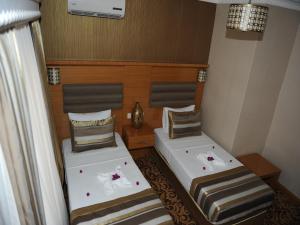 A bed or beds in a room at Alfa Hotel