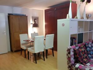 a dining room with a table and chairs and a couch at Appt Berlin in Berlin +7 photos