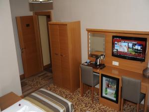 A television and/or entertainment centre at Alfa Hotel