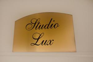 a sign for a hotel room with the word hudula lux at Apartment Exclusive and Studio in Subotica