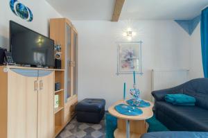 a living room with a couch and a tv at Haus Sonnenschein in Gößweinstein