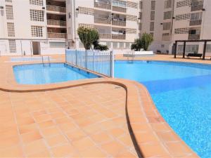 a swimming pool in the middle of a building at BONAIRE - PRIMERA LÍNEA DE PLAYA in Playa de Gandia