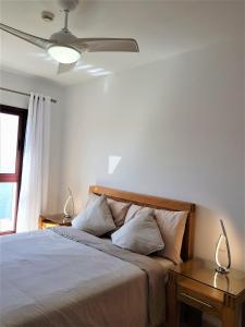 a bedroom with a bed with two lamps on a table at Su Eminencia - 2 bedrooms 5 star Playa Del Cura in Playa del Cura