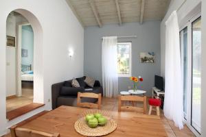 ein Wohnzimmer mit einem Sofa und einem Tisch in der Unterkunft Pamar Village in Lefkada Town