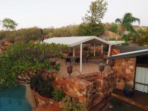 a house with a swimming pool and a pavilion at Wilmots on Dixon in Alice Springs