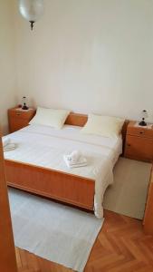 a bed in a room with two nightstands at Apartmani Ante in Posedarje