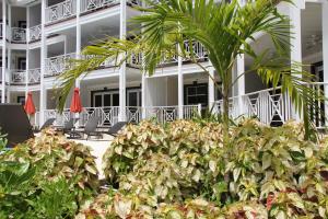 a hotel with palm trees in front of a building at Lantana Resort Barbados by Island Villas in Saint James