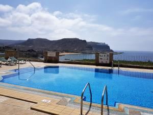 a large swimming pool with a view of the ocean at Su Eminencia - 2 bedrooms 5 star Playa Del Cura in Playa del Cura