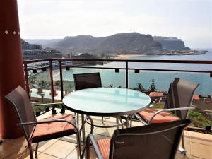 Su Eminencia - 2 bedrooms 5 star Playa Del Cura في بلايا ديل كورا: طاولة وكراسي على شرفة مطلة على المحيط