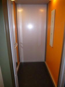 a hallway with a white door and an orange wall at Appartamento Iolanda in Tortoreto Lido