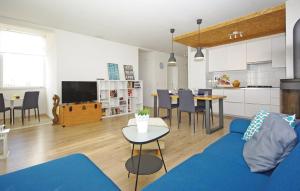 a living room with a blue couch and a kitchen at Apartment MIVA in Brela