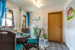 a room with a table and chairs and a door at Haus Sonnenschein in Gößweinstein