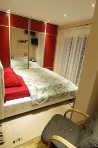 a bedroom with a large bed and a mirror at Kopernikus Apartments in Ulcinj +69 photos