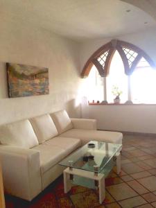 a living room with a couch and a glass coffee table at Casa Bellavista in Sorrento