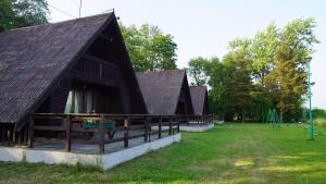 two large buildings with a playground in a field at Sunrise Camp Łazy in Łazy