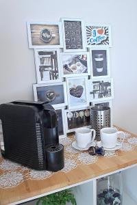 a table with a microwave and cups and pictures at Bayview Apartment in Selce