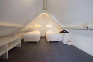 Posteľ alebo postele v izbe v ubytovaní 't Schelpenhuisje