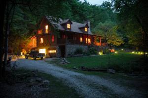 a large house with a truck parked in front of it at Creekside Paradise Bed and Breakfast in Robbinsville