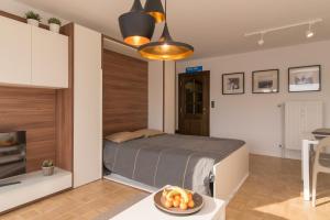 a bedroom with a bed and a bowl of fruit on a table at Studio Juan les Pins in Ostend