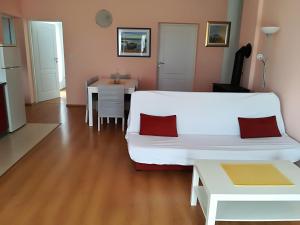 a living room with a white couch and a table at Apartman Rosanda in Premuda