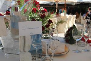 a table with wine glasses and a bottle on it at Hotel Lido Torre Egnazia in Monopoli