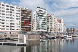a marina with boats in the water with buildings at Studio Juan les Pins in Ostend