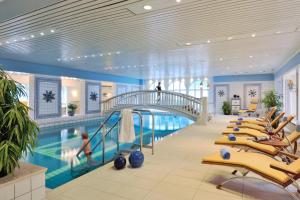 a pool in a hotel with a swimming pool at Badhotel Sternhagen in Cuxhaven
