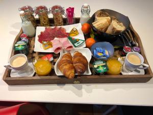 a tray of breakfast food on a table at La chambre des Onglous in Marseillan