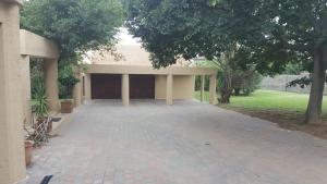 a building with a brick walkway in front of it at 2 Bedroom Cottage in Midrand