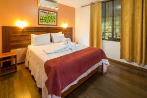 a hotel room with a bed with a stuffed animal on it at Manish Hotel Ecólogico in Pucallpa