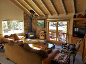 a living room with couches and a fire place at Dream Getaway with Secluded Spa in Big Bear Lake