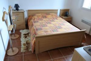 a bedroom with a bed and a dog on the floor at Patrimonio chambre avec commodités chez l’habitant in Patrimonio