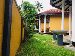 a sink in a yard next to a house at Rovenluck Eco Cabana in Weligama