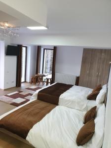 a bedroom with two large beds in a room at Nature House Predeal in Predeal