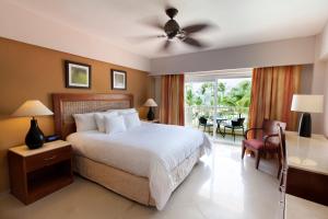 a bedroom with a bed and a table and chairs at Occidental Caribe - All Inclusive in Punta Cana