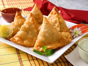 a plate of food with wontons on a table at Comfort Hotel Entebbe in Lyamutundwe