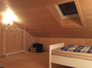 a bedroom with a bed in a wooden cabin at Mysig och modern Stuga på Snögård, nära havet och naturen in Lur